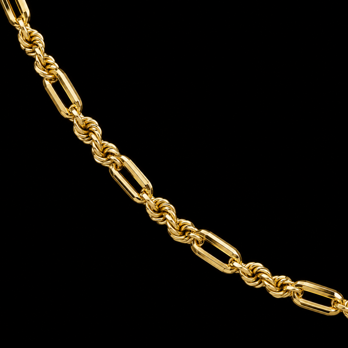 Detalle macro del tejido torsal fígaro de oro amarillo de 2 mm con eslabones alargados y tramos retorcidos